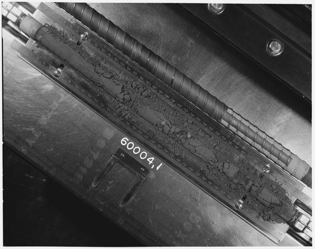 Black and white photograph of Apollo 16 Core Sample 60004,1; Processing photograph displaying an overview of the Core Tube .