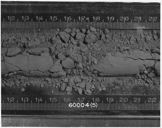 Black and white photograph of Apollo 16 Sample(s) 60004; 5 of 10 Processing photograph displaying Core Tube at 11.5-22.5 cm depth.