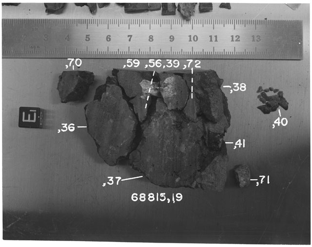 Black and white photograph of Apollo 16 Sample(s) 68815,19,36-41,56,59,70-72; Processing photograph displaying sawed surface reconstruction with an orientation of E.