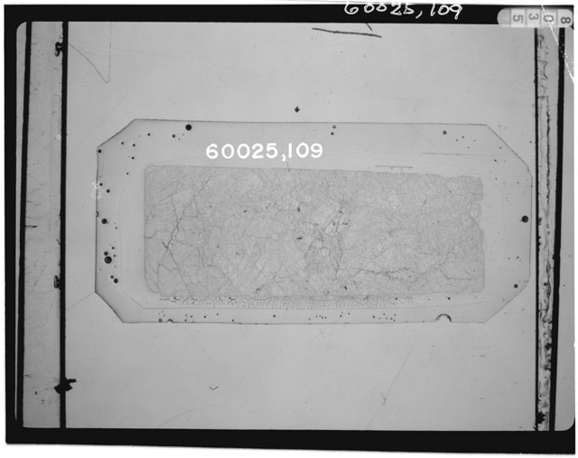 Black and white photograph of Apollo 16 Sample(s) 60025,109; Thin Section photograph using transmitted light.