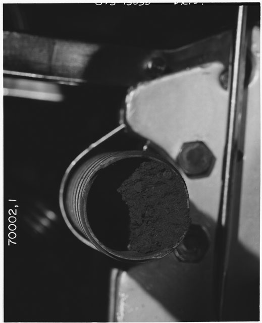 Black and white photograph of Apollo 17 Sample(s) 70002,1; Processing photograph displaying the bottom end of Core.