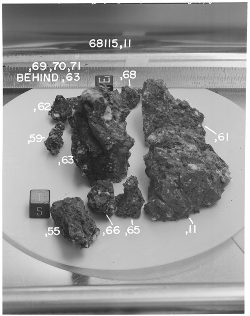 Black and white photograph of Apollo 16 Sample(s) 68115,11,55,59,61-3,65-6; Processing photograph displaying reconstruction with an orientation of S,T.