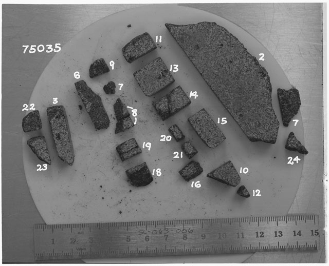 Black and white photograph of Apollo 17 Sample(s) 75035,2,3,6-24; Processing photograph displaying a group of slabs.