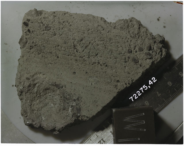 Color photograph of Apollo 17 Sample(s)72275,42; Processing photograph displaying slab with an orientation of W.