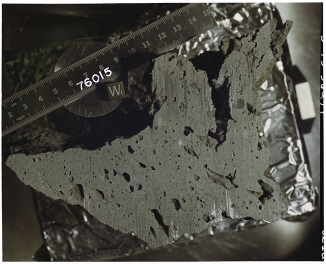 Color photograph of Apollo 17 Sample(s) 76015; Processing photograph displaying slabbing with an orientation of W.