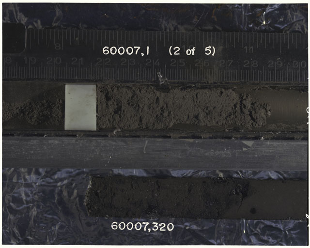 Color photograph of Apollo 16 Sample(s) 60007,1,320; 2 OF 5 Processing photograph displaying Core with peel at 18-30 cm depth.