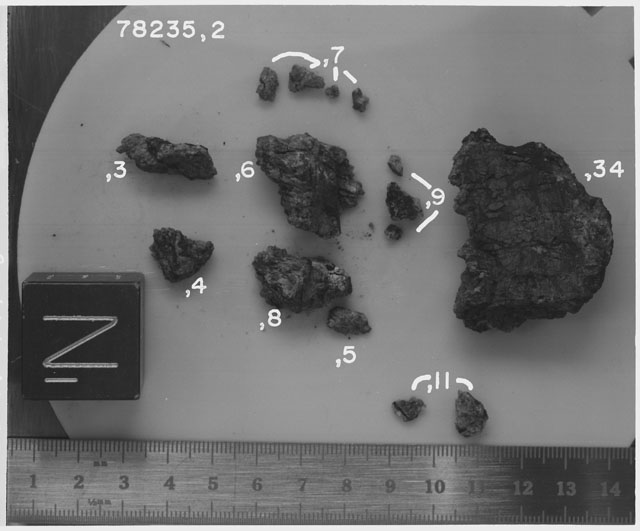 Black and white photograph of Apollo 17 Sample(s) 78235,2-11,34; Processing photograph displaying chips, fragments and fines group with an orientation of N.
