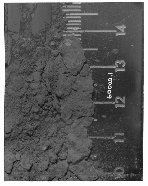 Black and white photograph of Apollo 16 Core Sample 60002,1; Processing photograph displaying Core Fines pre-removal.