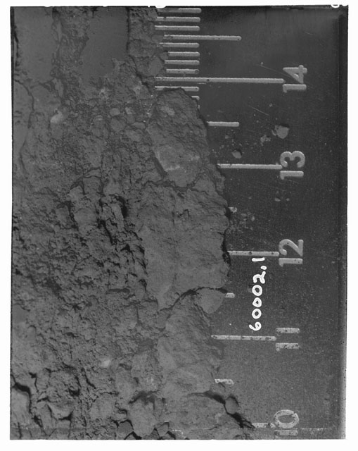 Black and white photograph of Apollo 16 Core Sample 60002,1; Processing photograph displaying Core Fines pre-removal.