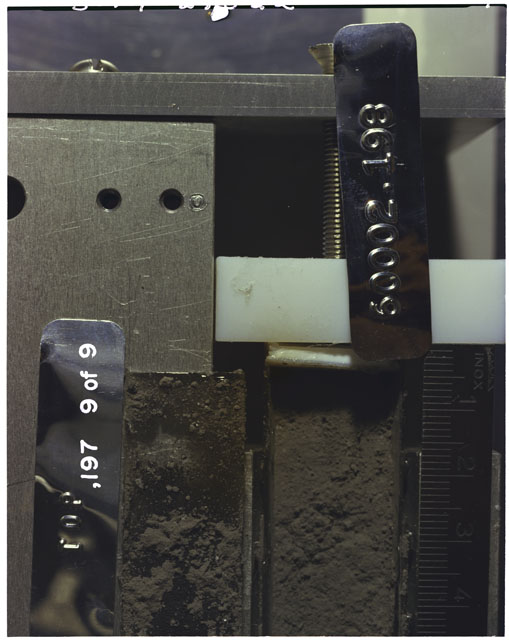 Color photograph of Apollo 16 Sample(s) 60002,197,198; 9 of 9 Processing photograph displaying Core Tube with peel at 0-4.5 cm depth.