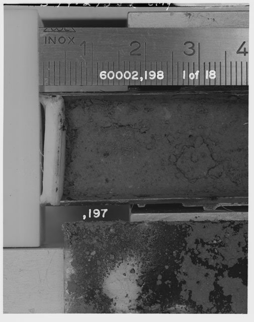 Black and white photograph of Apollo 16 Sample(s) 60002,197,198; 1 of 18 Processing photograph displaying Core Tube with peel at 0-4 cm depth.