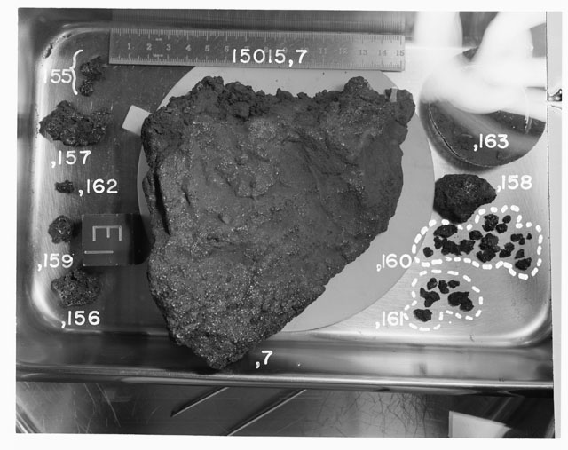 Black and white photograph of Apollo 17 Rake Sample(s) 75055,19,60-63; Processing photograph displying a post chip Cow Cake reconstruction with an orientation of T.