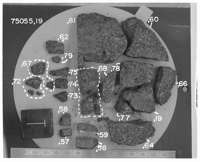 Black and white photograph of Apollo 17 Rake Sample(s) 75055,19,56-62,64,66-68,72-78; Processing photograph displying a post chip Cow Cake reconstruction with an orientation of T.