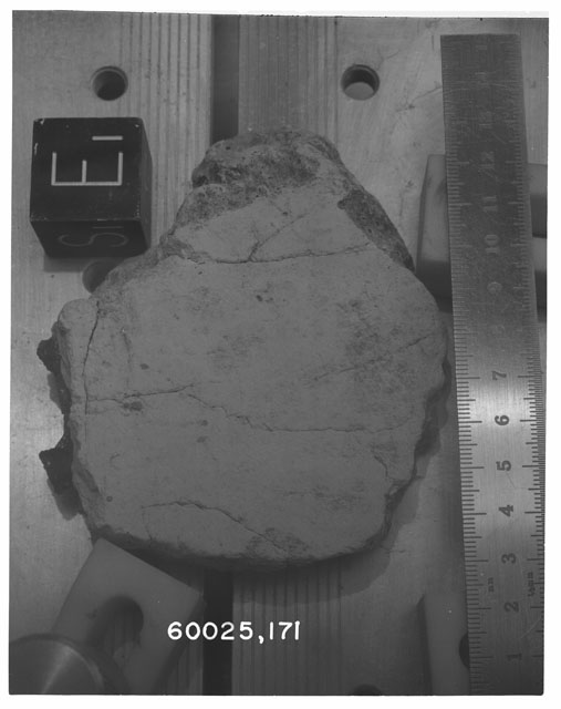 Black and white photograph of Apollo 16 Sample(s) 60025,171; Processing photograph displaying slab with an orientation of S,E.