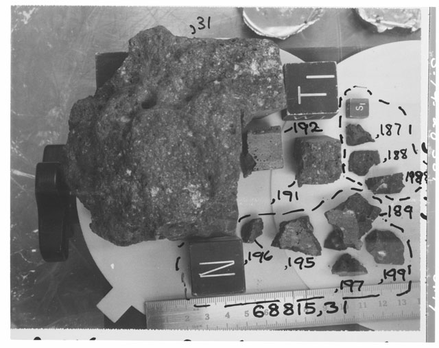 Black and white photograph of Apollo 16 Sample(s) 68815,31,187-189,191,192,195-199; Processing photograph displaying group with an orientation of N,T.