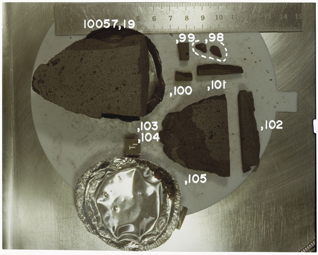Color photograph of Apollo 11 Sample(s) 10057,19,98-105; Processing photograph displaying reconstruction with an orientation of T.