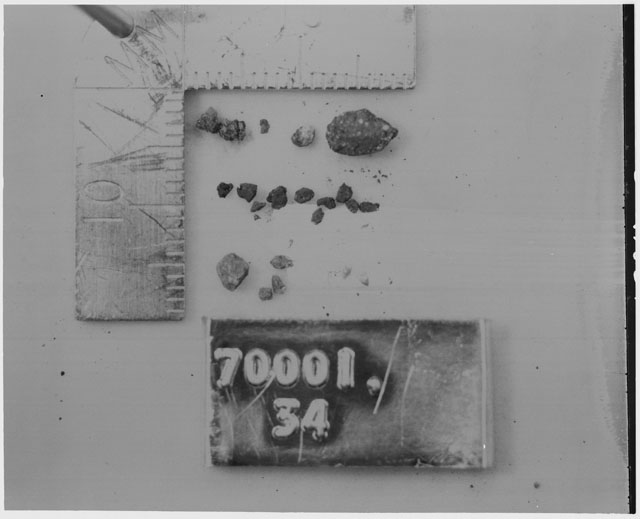 Black and white photograph of Apollo 17 Sample(s) 70001,34; Processing photograph displaying a group of <1 MM Core Fines.