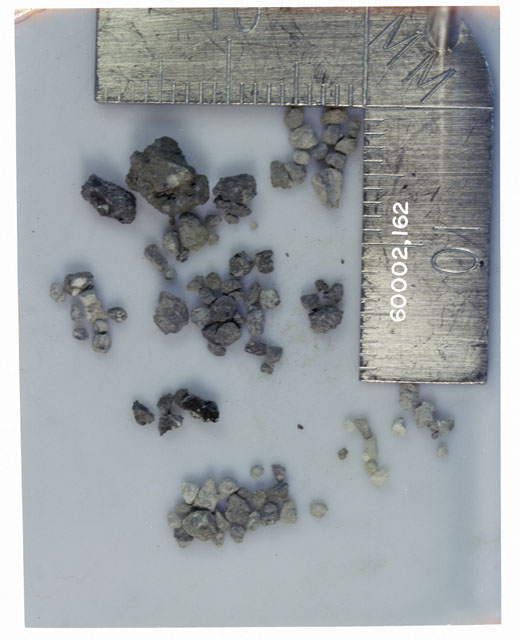 Color photograph of Apollo 16 Core Sample 60002,162; Processing photograph displaying >1 MM Core Fines .