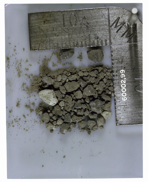 Color photograph of Apollo 16 Core Sample 60002,99; Processing photograph displaying >1 MM Core Fines .