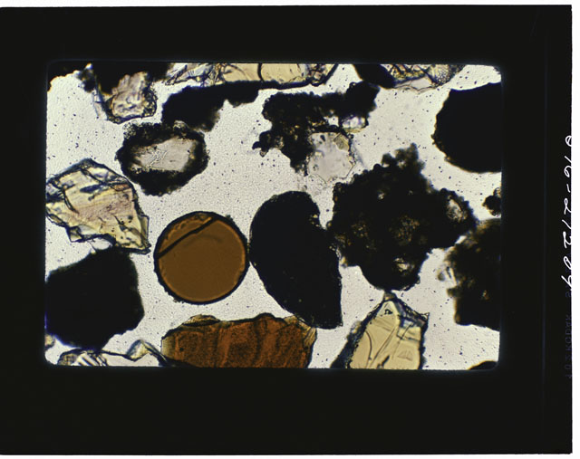 Color photograph of Apollo 17 Sample(s) 75081 ; Thin Section photograph displaying orange glass beads and agglutinates.