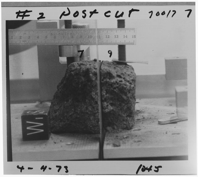 Black and white photograph of Apollo 17 Sample(s) 70017,7,9; Processing photograph displaying post-cut sample with an orientation of SW.