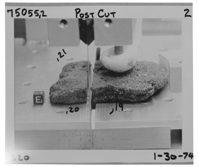 Black and white photograph of Apollo 17 Rake Sample(s) 75055,19-21; Processing photograph displaying the orientation of post cut Cow Cake sample.