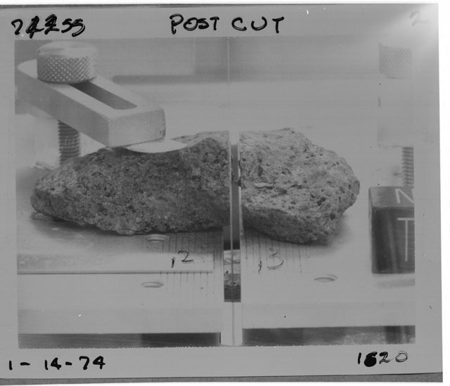 Black and white photograph of Apollo 17 Sample(s) 74255,2,3; Processing photograph displaying  post cut sample with an orientation of N,T.