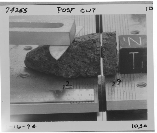 Black and white photograph of Apollo 17 Sample(s) 74255,2,9; Processing photograph displaying  post cut sample with an orientation of N,T.