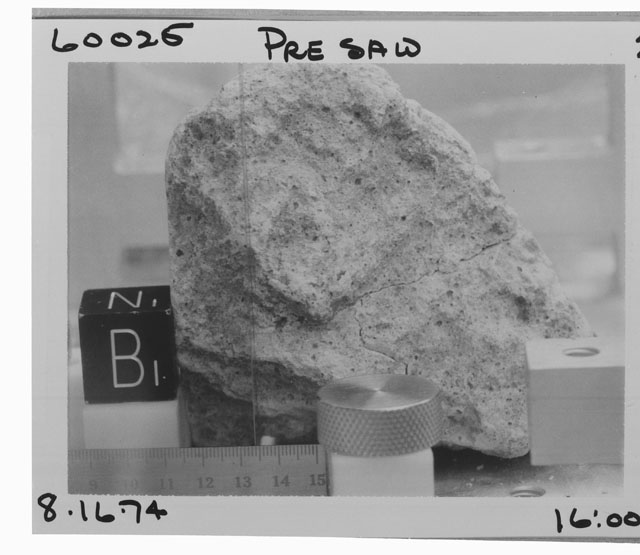 Black and white photograph of Apollo 16 Sample(s) 60025; Processing photograph displaying close-up view of pre-sawed sample.