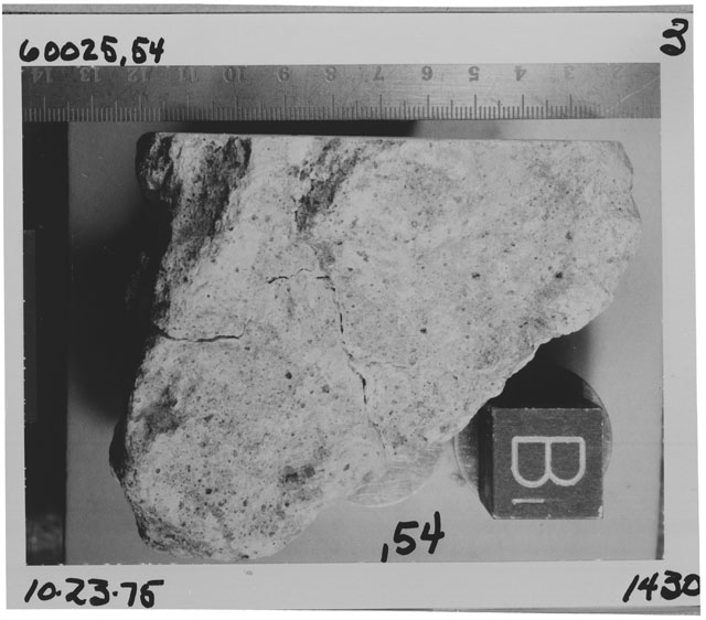 Black and white photograph of Apollo 16 Sample(s) 60025,54; Processing photograph displaying close-up view of post sawed sample.