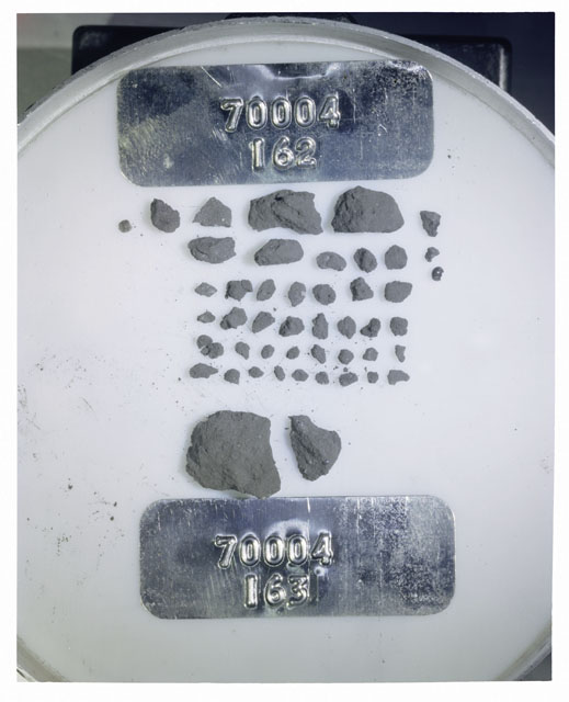 Color photograph of Apollo 17 Sample(s) 70004,162,163; Processing photograph displaying a group of >1 MM Core Fines found at 196.7-197.2 cm depth from surface.