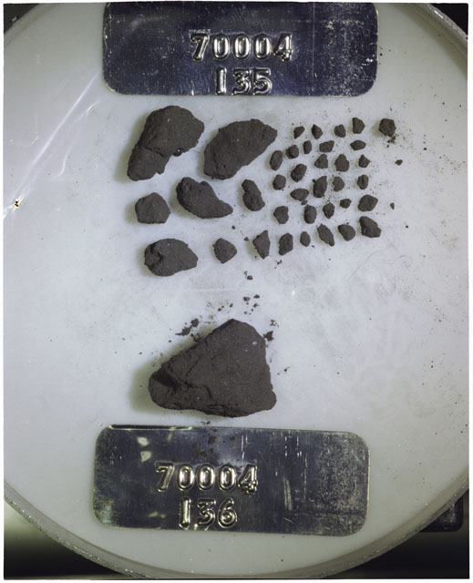 Color photograph of Apollo 17 Sample(s) 70004,135,136; Processing photograph displaying a group of >1 MM Core Fines found at 192.2-192.7 cm depth from surface.