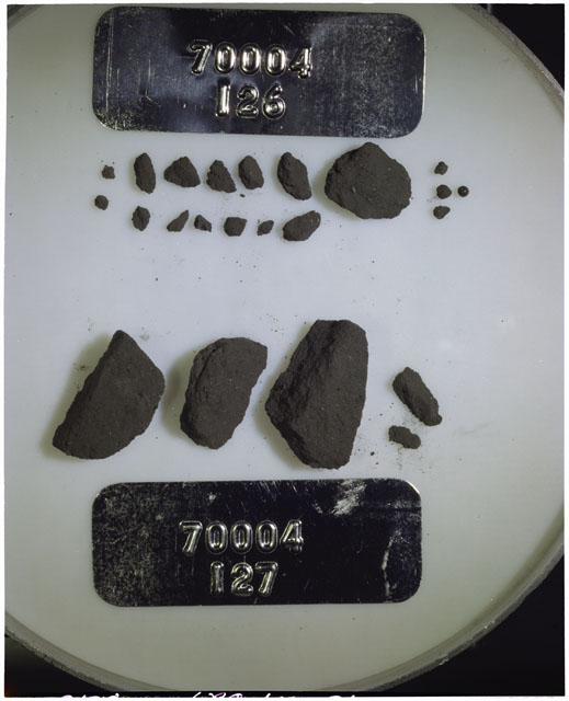 Color photograph of Apollo 17 Sample(s) 70004,126,127; Processing photograph displaying a group of >1 MM Core Fines found at 190.7-191.2 cm depth from surface.