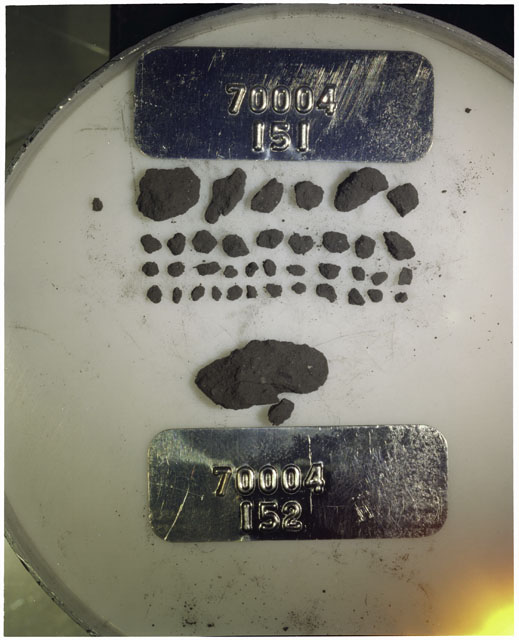Color photograph of Apollo 17 Sample(s) 70004,151,152; Processing photograph displaying a group of >1 MM Core Fines found at 195.2-195.7 cm depth from surface.