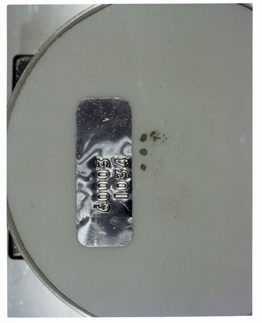 Color photograph of Apollo 16 Core Sample 60003,1034; Processing photograph displaying >1 MM Core Fines .