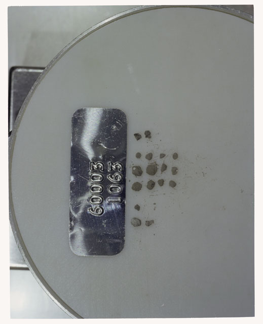 Color photograph of Apollo 16 Core Sample 60003,1063; Processing photograph displaying >1 MM Core Fines .