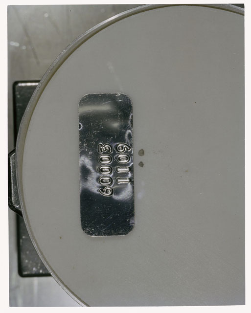 Color photograph of Apollo 16 Core Sample 60003,1109; Processing photograph displaying >1 MM Core Fines .