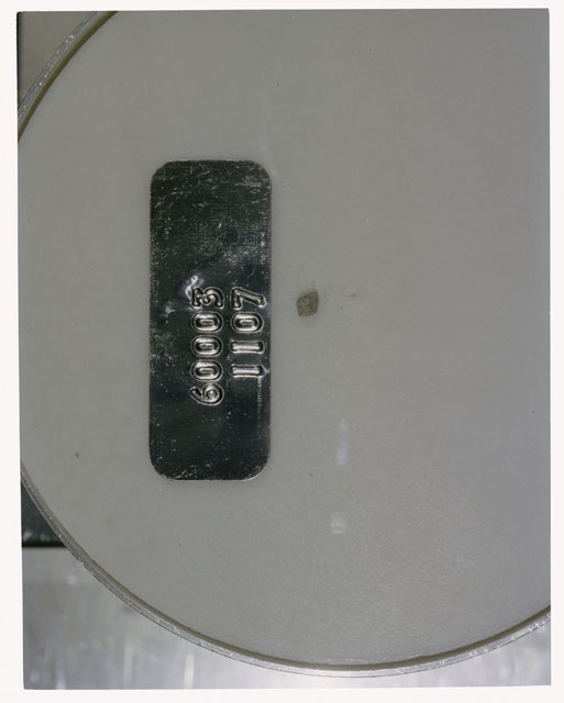 Color photograph of Apollo 16 Core Sample 60003,1107; Processing photograph displaying >1 MM Core Fines .