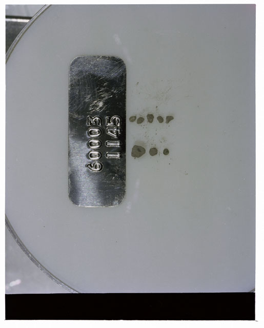 Color photograph of Apollo 16 Core Sample 60003,1145; Processing photograph displaying >1 MM Core Fines .