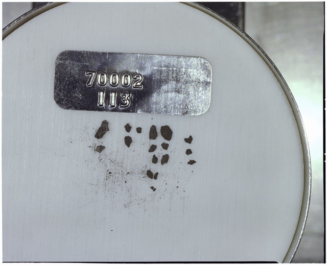 Color photograph of Apollo 17 Sample(s) 70002,113; Processing photograph displaying a group of >1 MM Core Fines.
