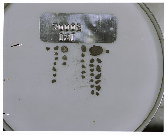 Color photograph of Apollo 17 Sample(s) 70002,121; Processing photograph displaying a group of >1 MM Core Fines.