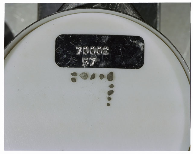 Color photograph of Apollo 17 Sample(s) 70002,57; Processing photograph displaying a group of >1 MM Core Fines.