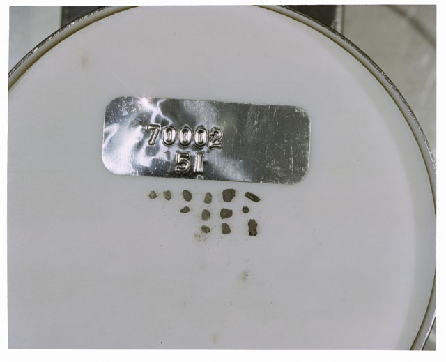 Color photograph of Apollo 17 Sample(s) 70002,51; Processing photograph displaying a group of >1 MM Core Fines.