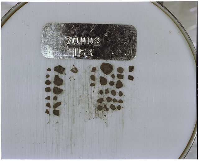 Color photograph of Apollo 17 Sample(s) 70002,153; Processing photograph displaying a group of >1 MM Core Fines.