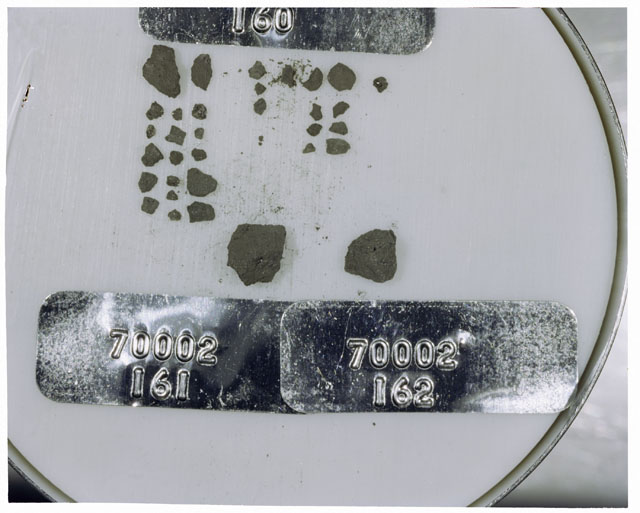 Color photograph of Apollo 17 Sample(s) 70002,160,161,162; Processing photograph displaying a group of >1 MM Core Fines.