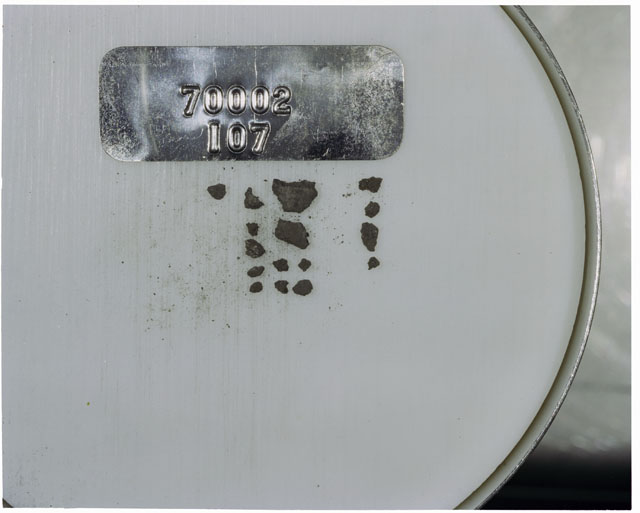 Color photograph of Apollo 17 Sample(s) 70002,107; Processing photograph displaying a group of >1 MM Core Fines.