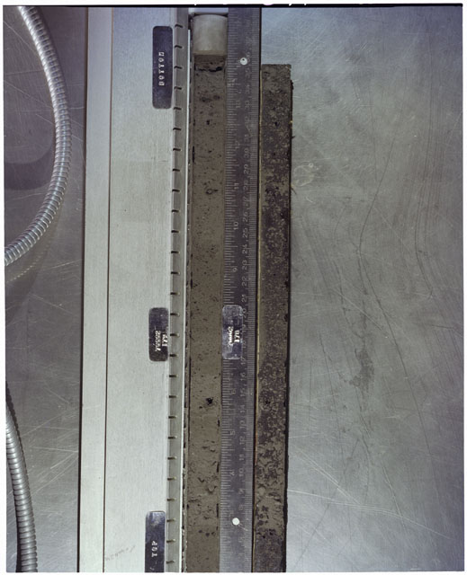 Color photograph of Apollo 17 Sample(s) 70002,179,178; Processing photograph displaying full view of Core with peel.