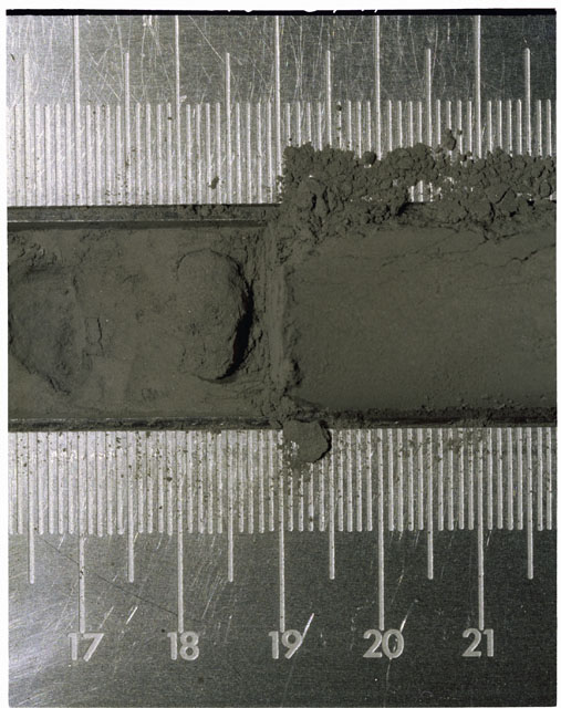 Color photograph of Apollo 17 Sample(s) 70003; Close-up Processing photograph displaying Core at 16.5-21.5 cm depth.