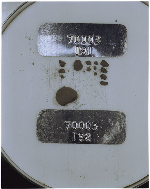 Color photograph of Apollo 17 Sample(s) 70003,191,192; Processing photograph displaying a group of >1 MM Core Fines found at 250.7-251.2 cm depth from surface.