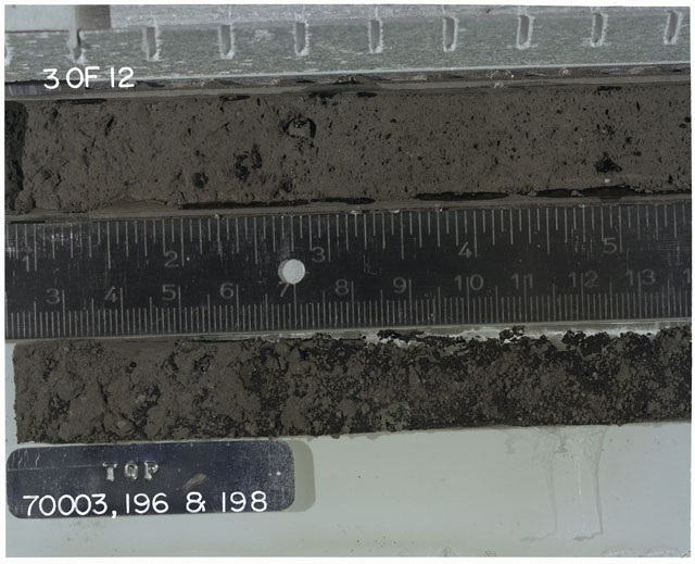 Color photograph of Apollo 17 Sample(s) 70003,196,198; 3 of 12 Processing photograph displaying Core with peel at 2.5-13.5 cm depth.